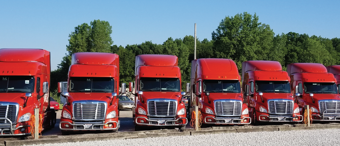 Classic carriers trucks parked in a line at a truck stop