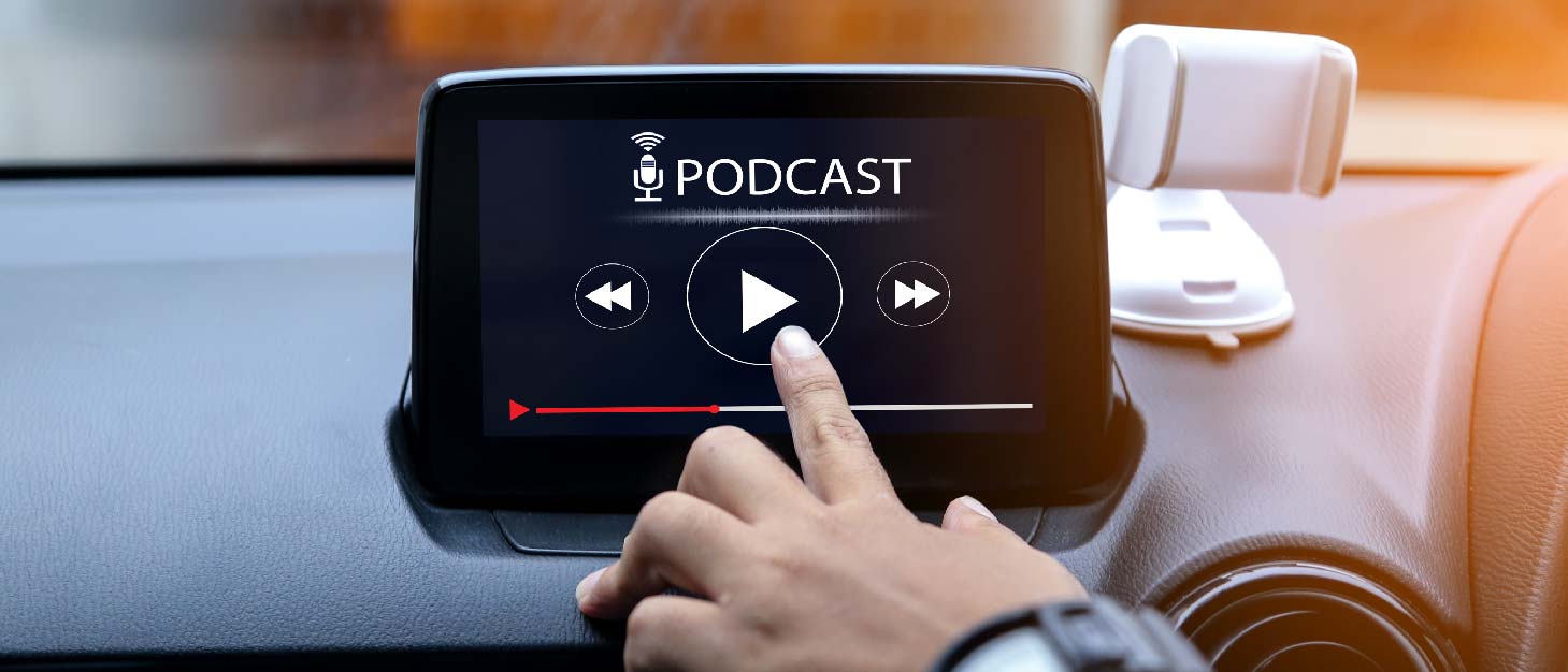 A man pressing play on a podcast in a car